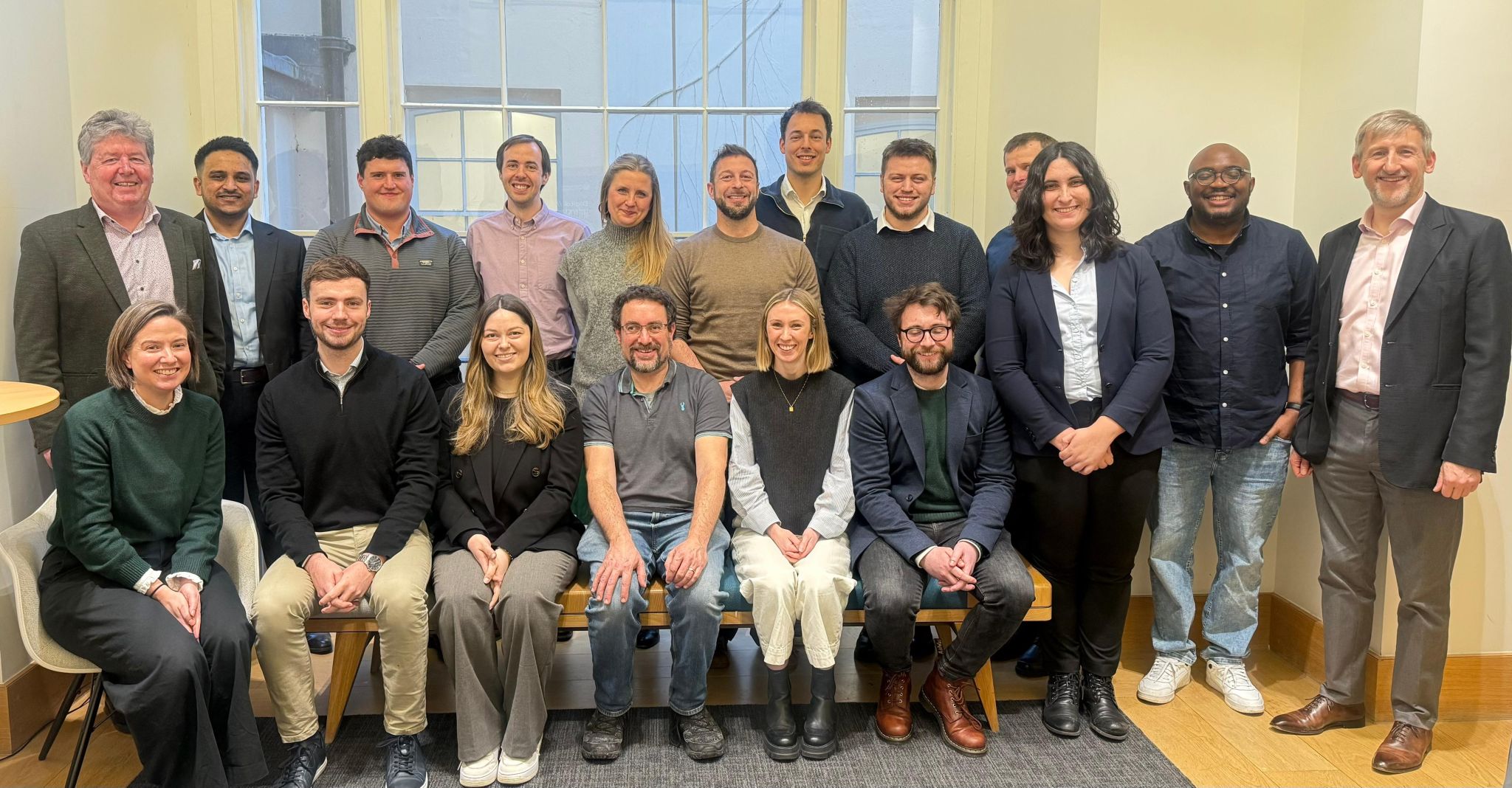 Enterprise Fellowships awardees stand in a group, smiling towards the camera.
