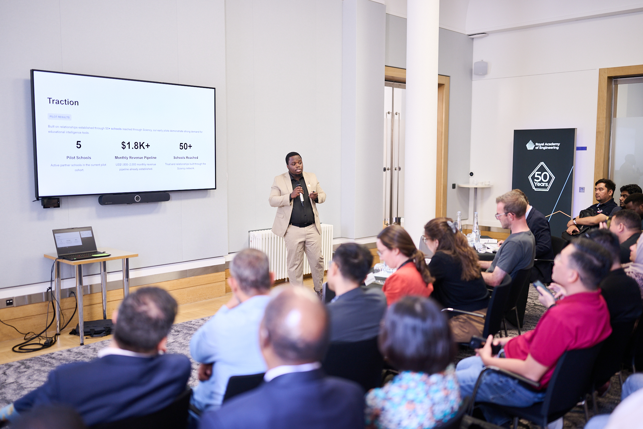 Person speaking to room of people.
