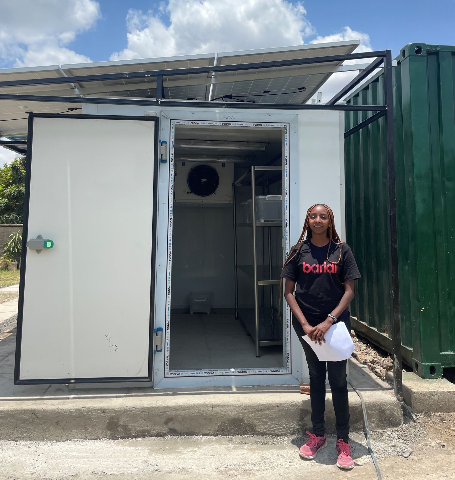 Tracy, founder outside a solar panelled Cold room