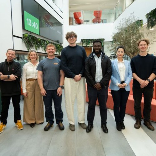 A group of people stood smiling at the camera.