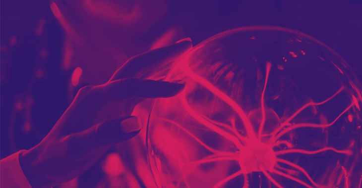A woman's hand touching a plasma globe