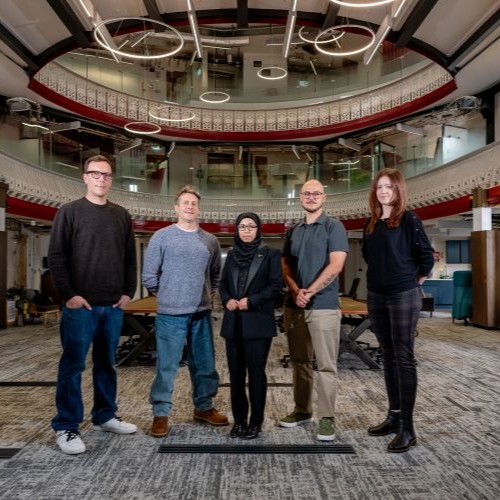 A group of five people stood smiling at the camera.
