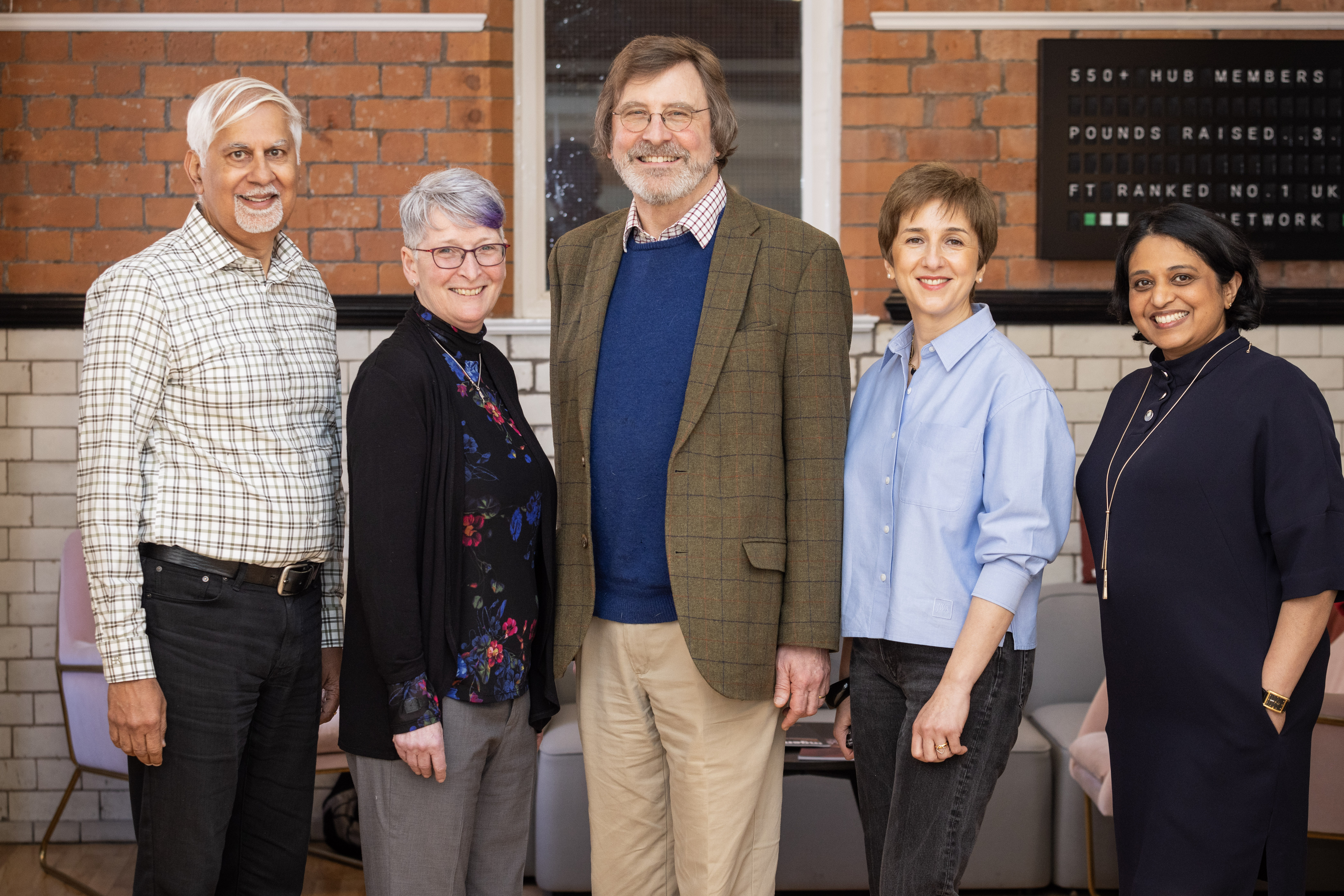 Photo of Ana Avaliana, Director of Enterprise Hub, with four regional entrepreneurs at Enterprise Hub Northern Ireland in Belfast.