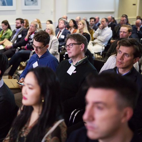 People sitting in chairs paying attention at a hub pitch event