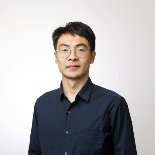 A professional headshot of Dr Yang Song smiling wearing a navy blue button up shirt.