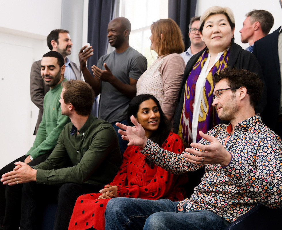 A group of people talking together.