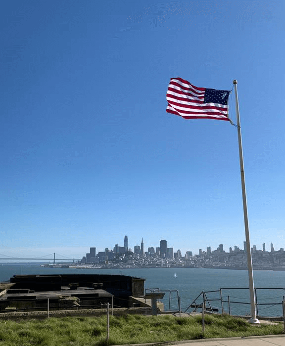 American flag flying over San Francisco bay