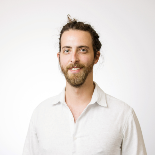 A professional headshot of Emanuele Griccioli smiling wearing a white button up shirt